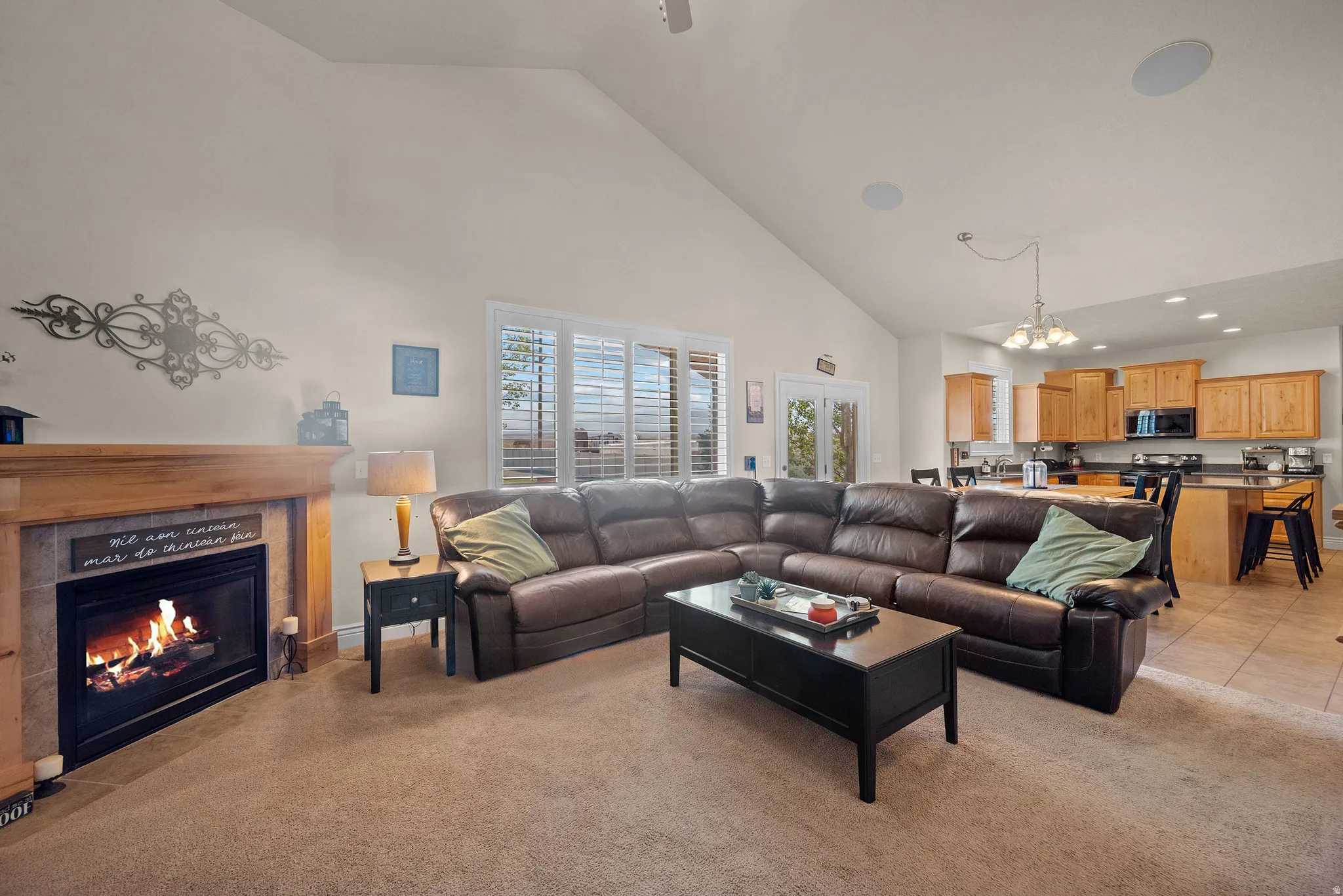 Vaulted ceiling, fireplace with wood mantel, plantation shutters