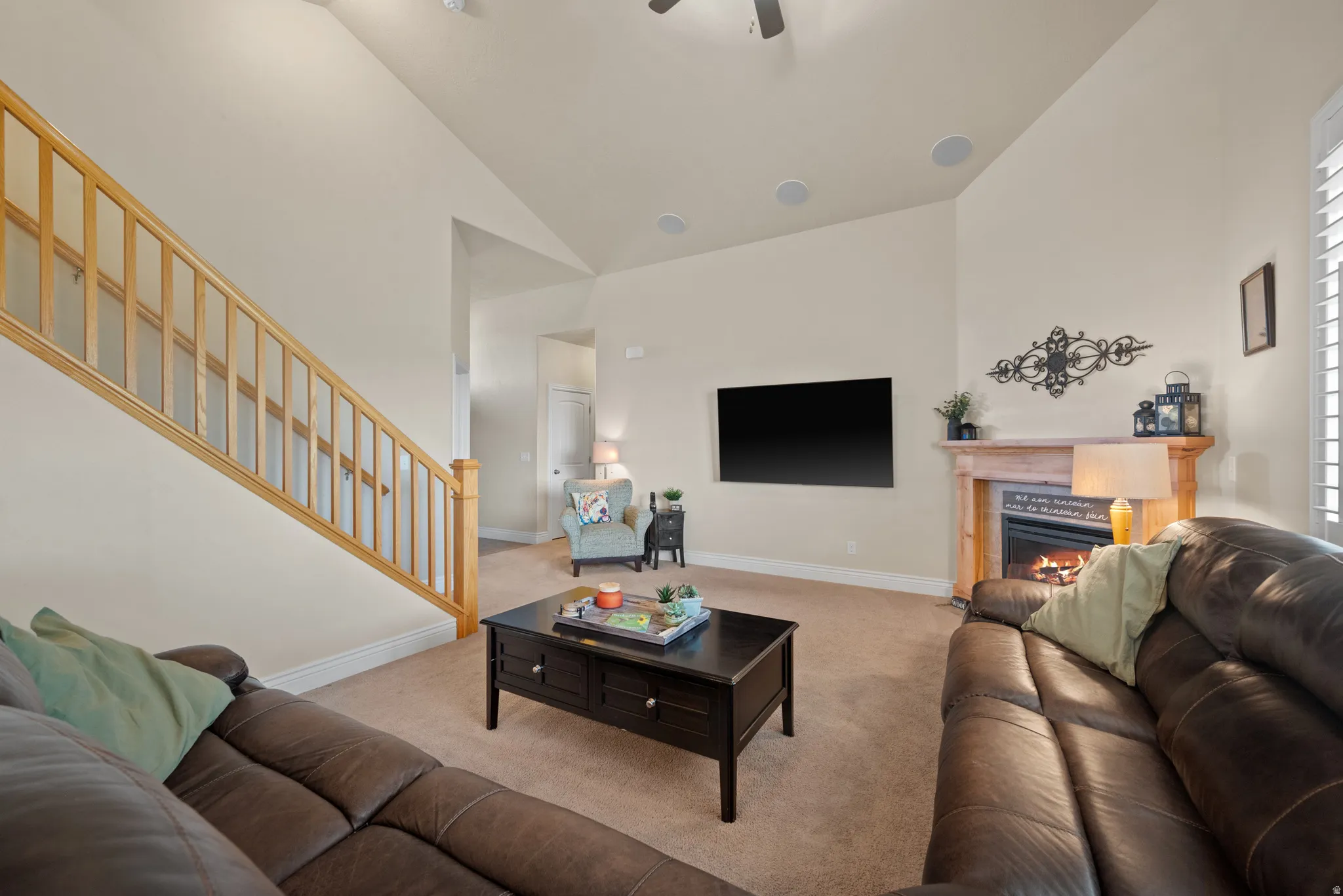 Vaulted ceiling with recessed lighting, integrated ceiling speakers, and a ceiling fan