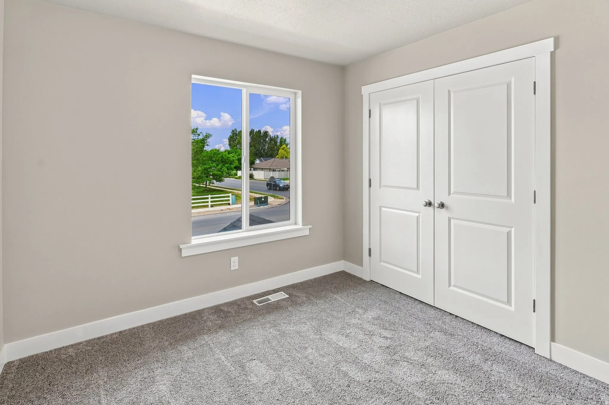 Double-panel closet doors, light-colored walls, and gray carpet