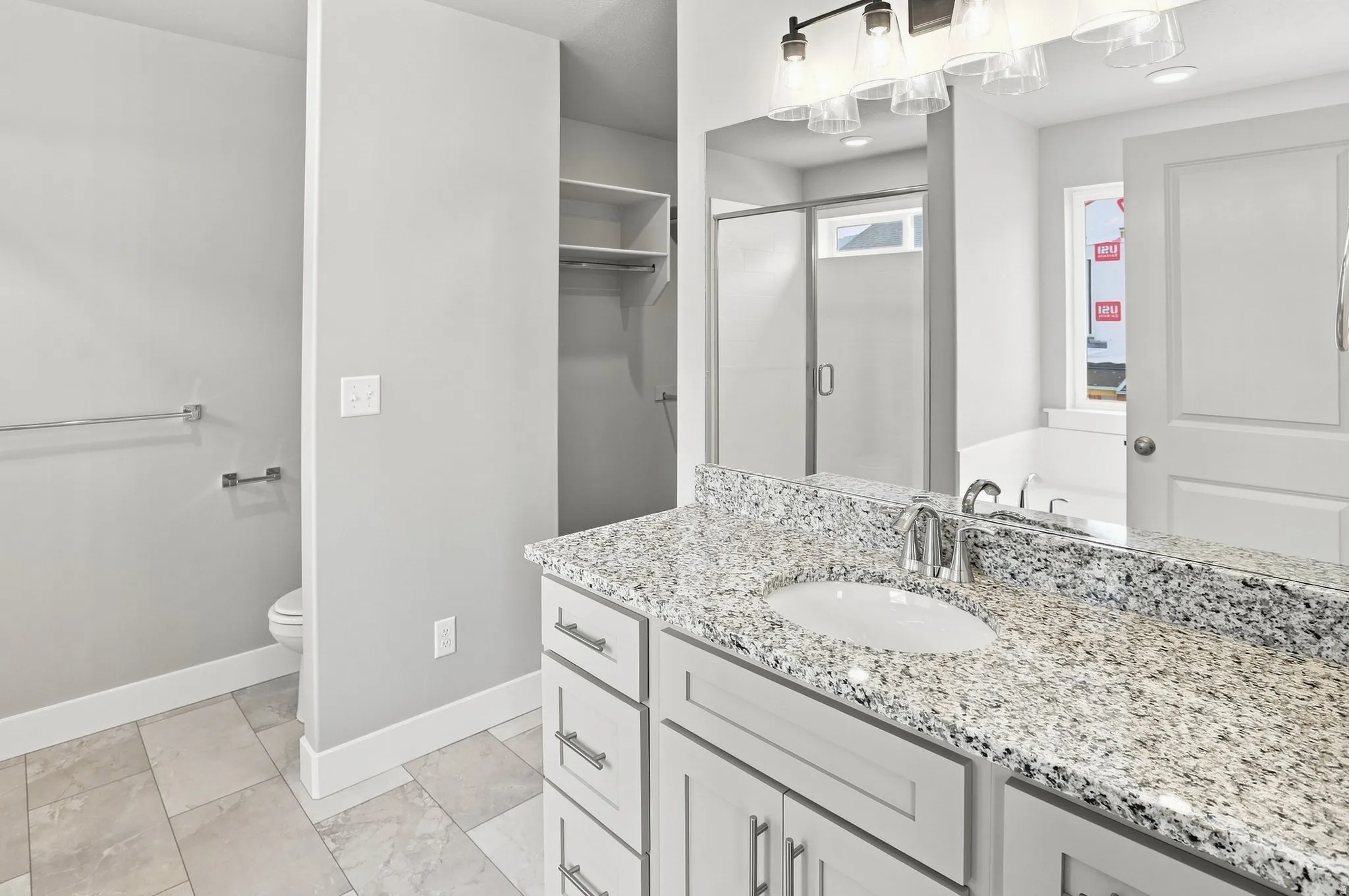 Double vanity with a granite countertop, undermount sinks, and chrome faucets