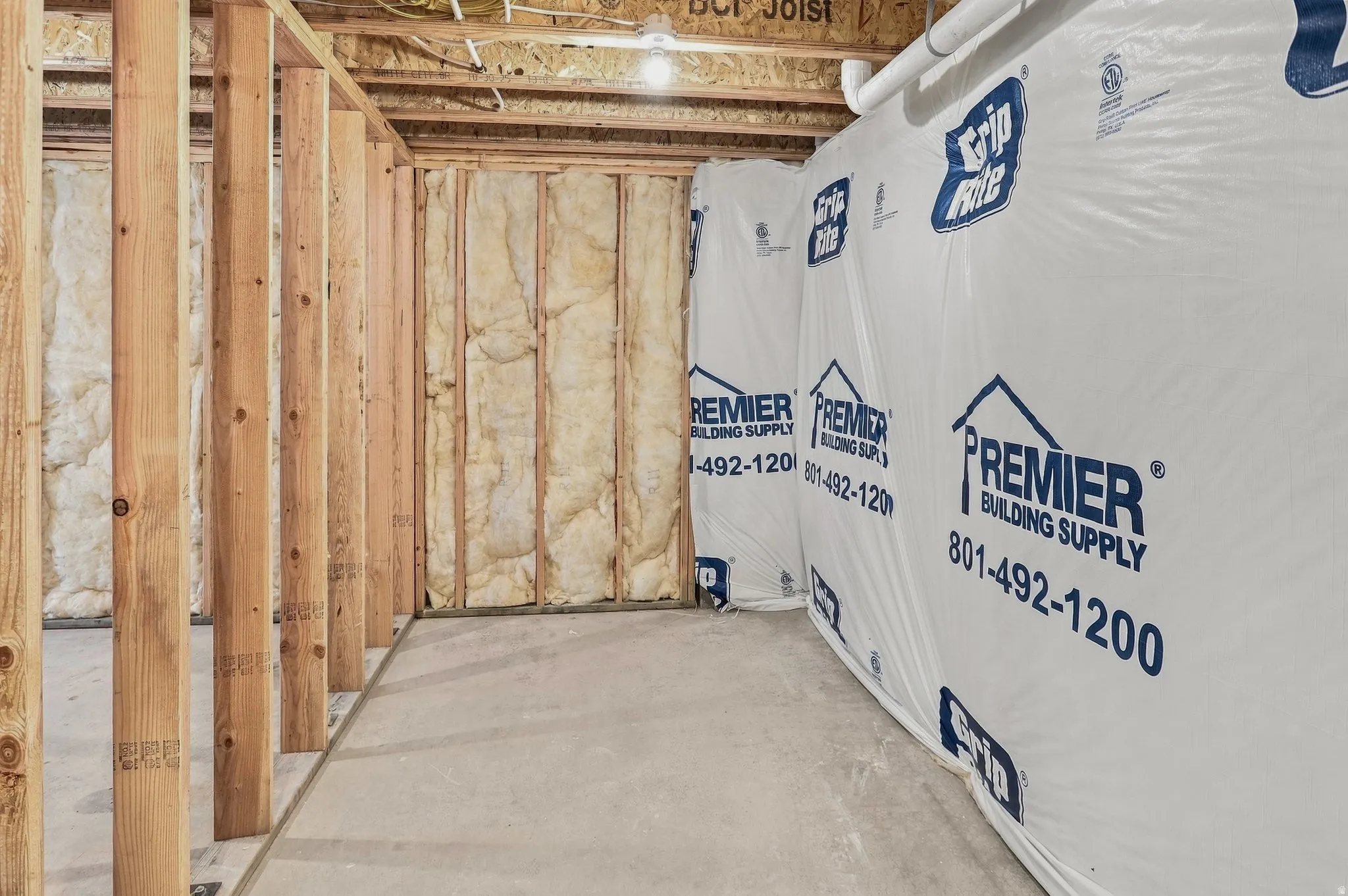Exposed wood framing, concrete flooring, and insulated walls