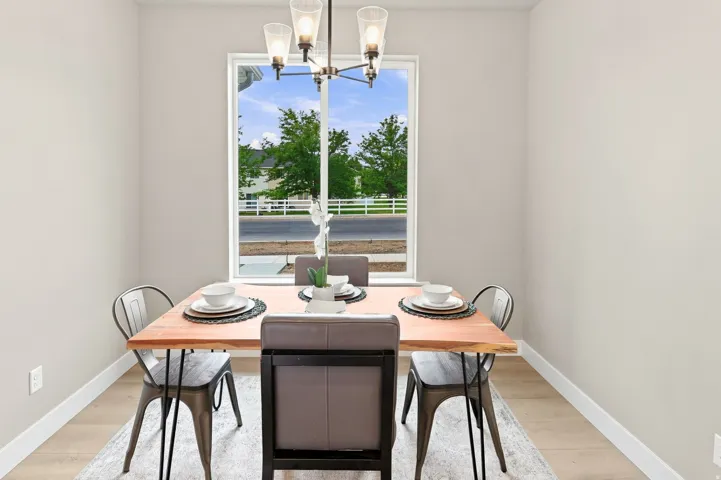 Recessed window with white trim, wood-finish flooring, and a modern chandelier