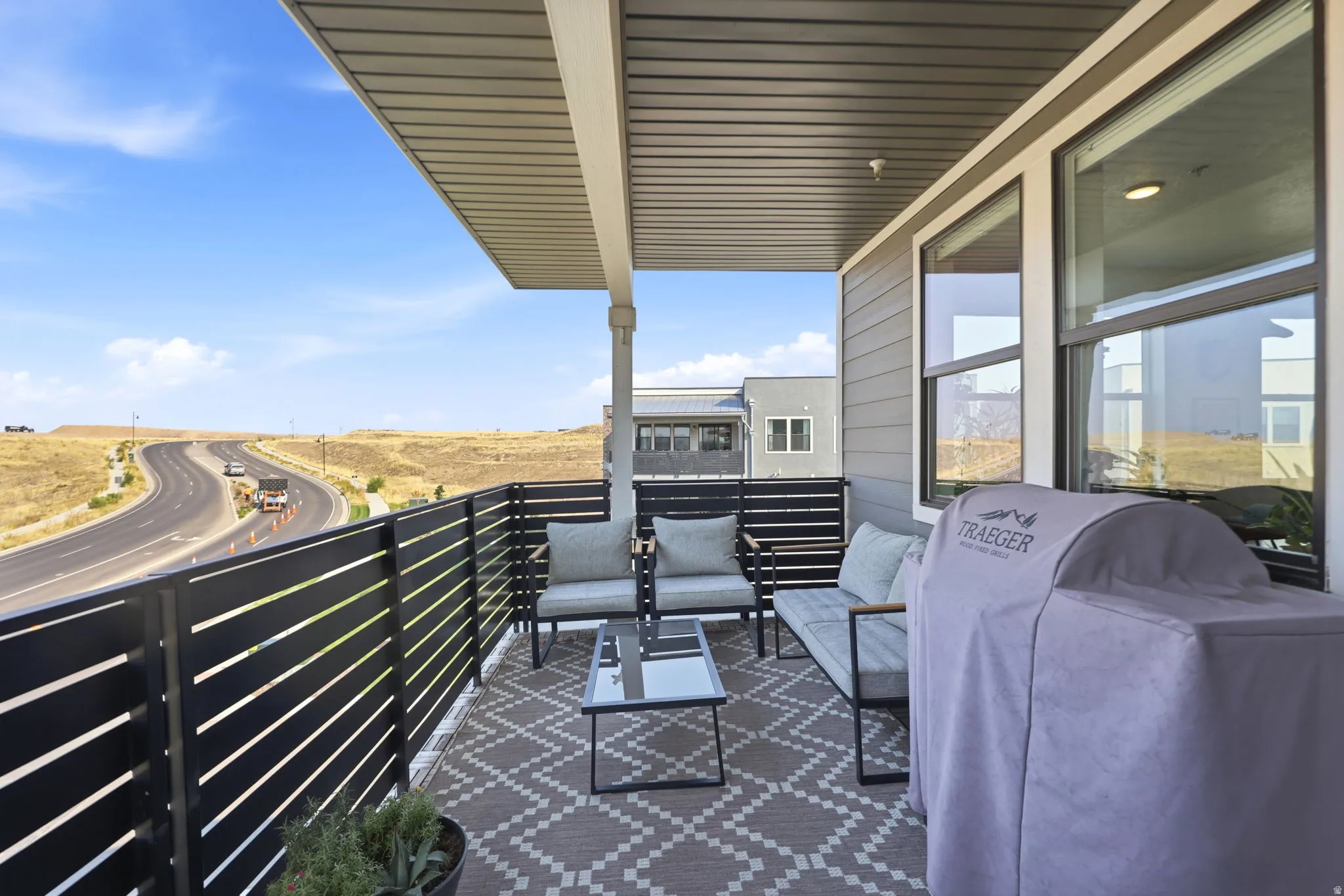 Covered outdoor patio with composite decking and a slatted privacy fence
