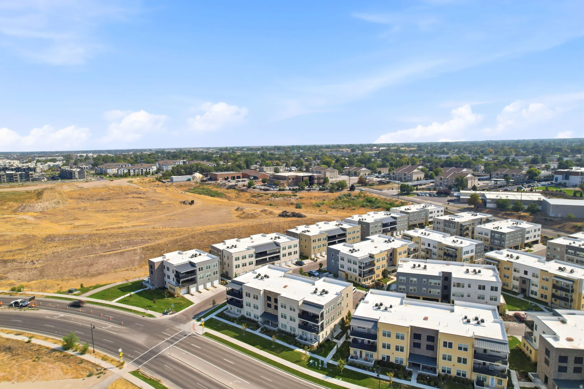 Modern multi-story apartment buildings featuring balconies and a consistent architectural design