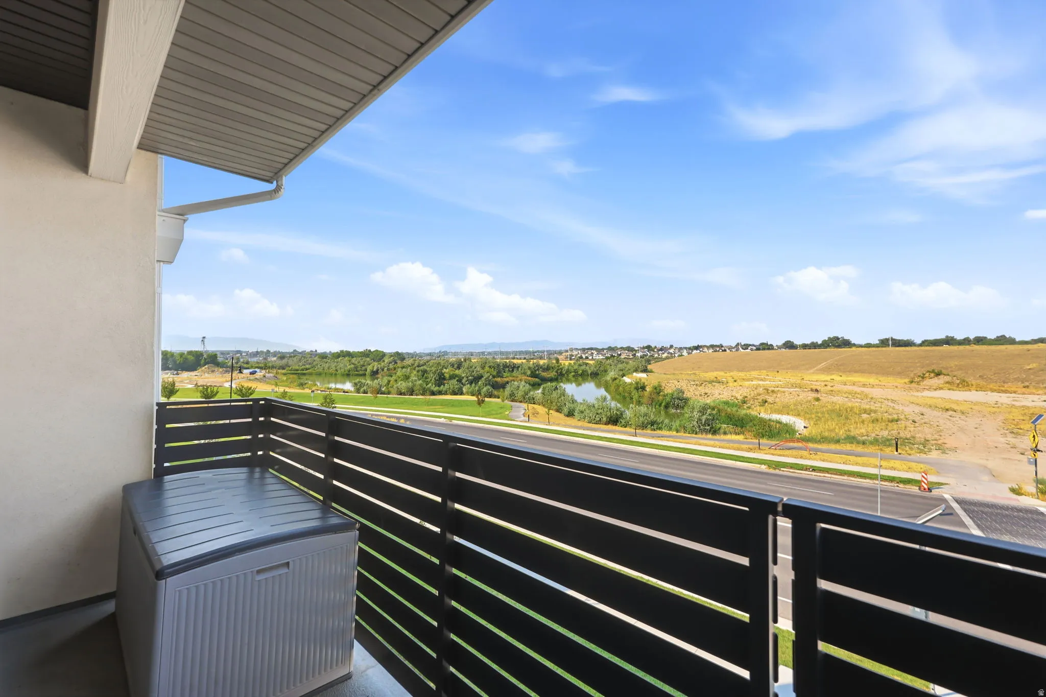 Balcony with slatted railing, providing a broad outdoor landscape
