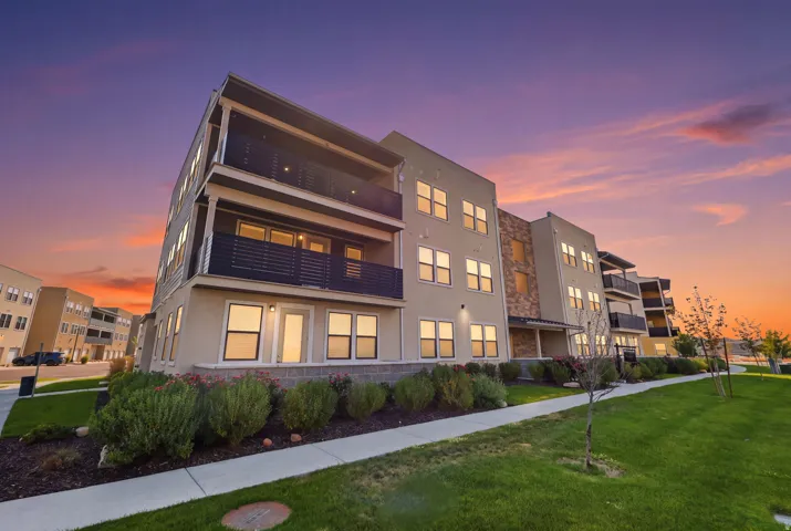 Multi-story building featuring stucco and stone veneer exterior