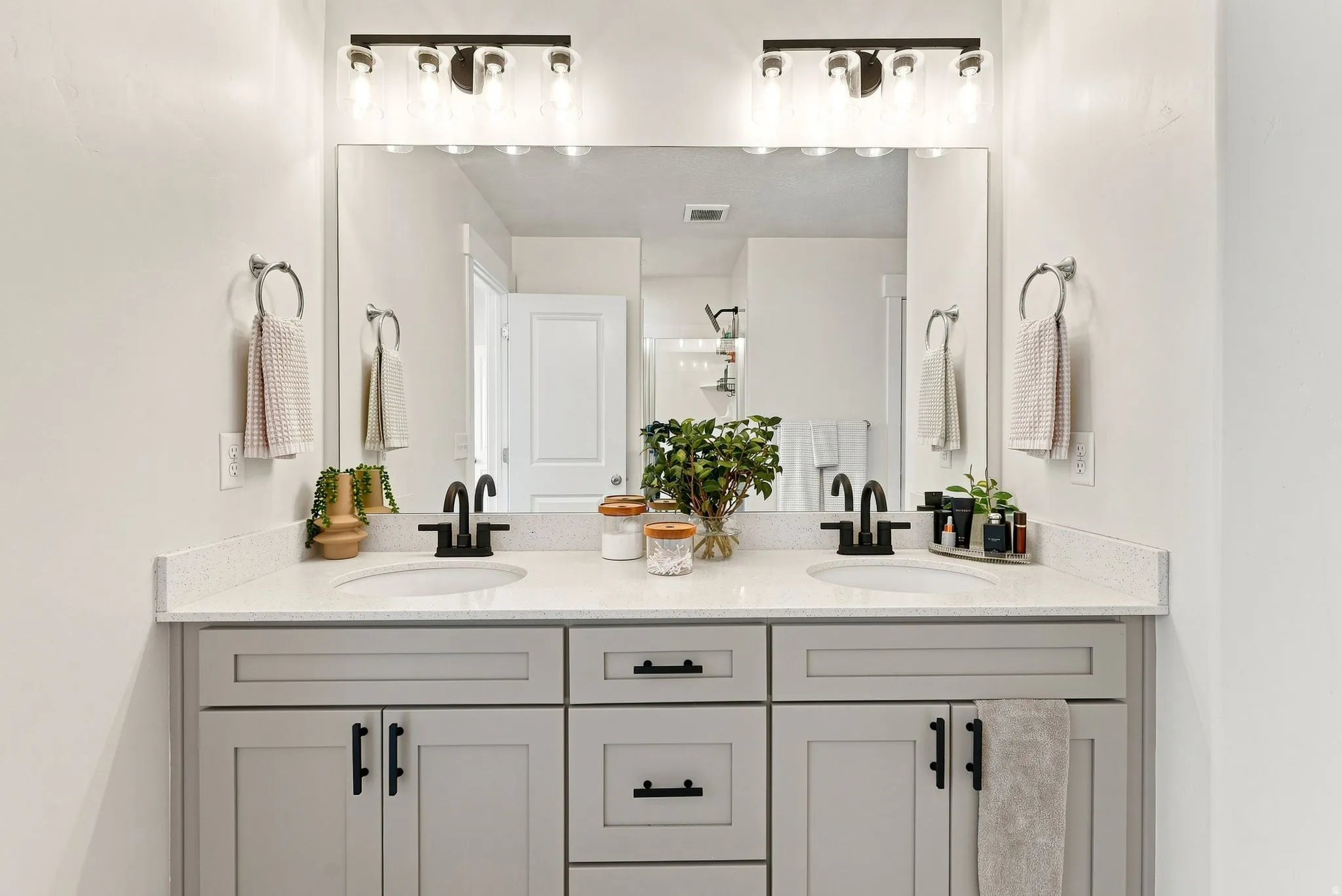 Primary Bath, dual vanity with quartz-finish countertop, undermount sinks, and matte black fixtures