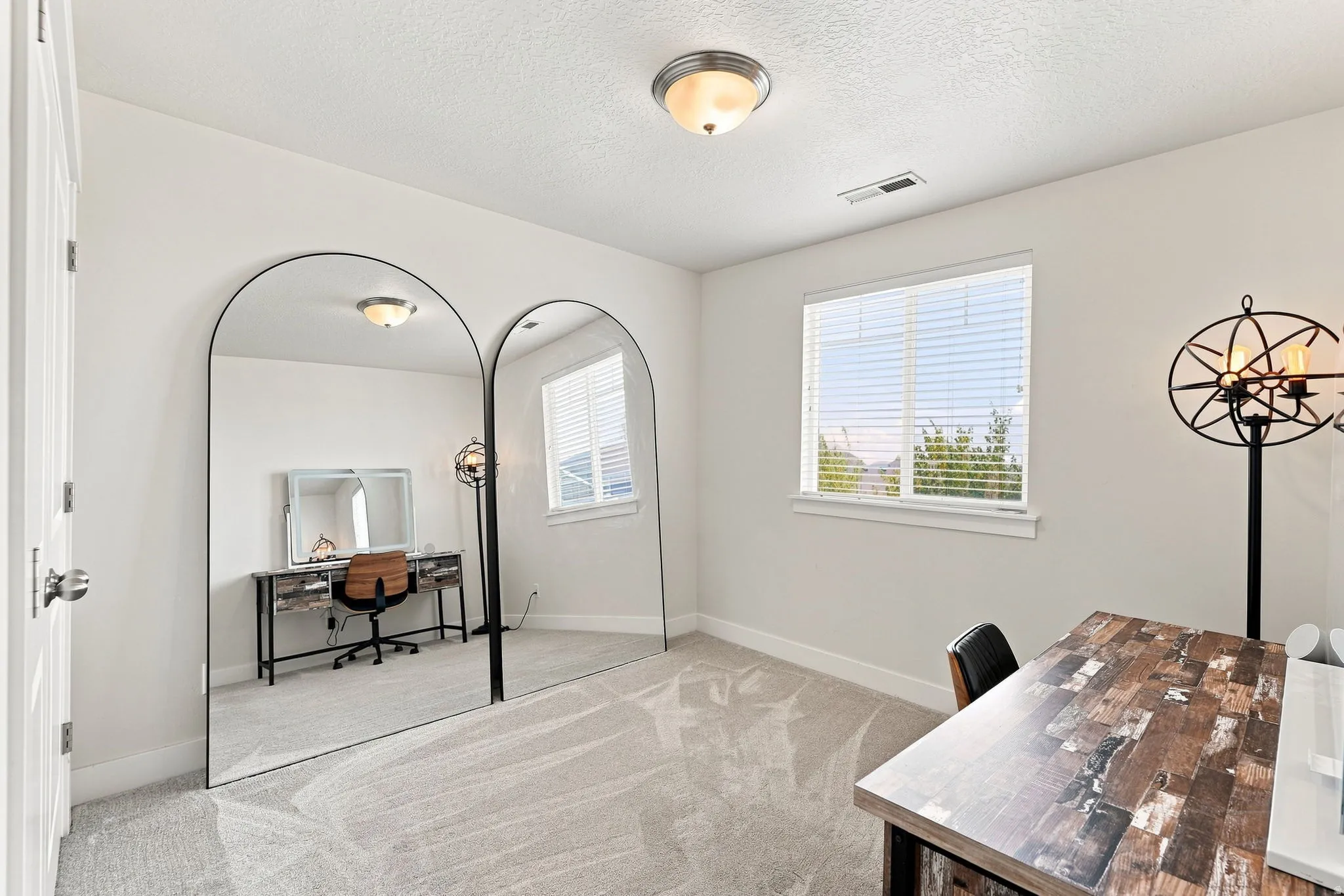 Carpeted flooring, white interior walls, and a single window with blinds