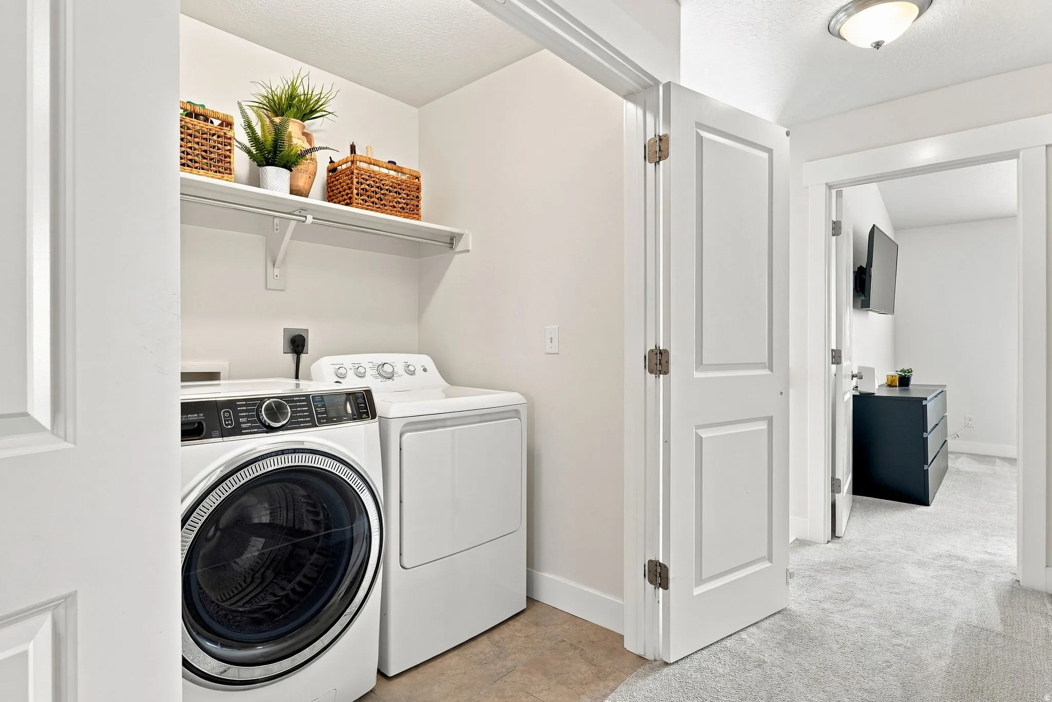 Dedicated laundry area with a built-in shelf and hanging rod