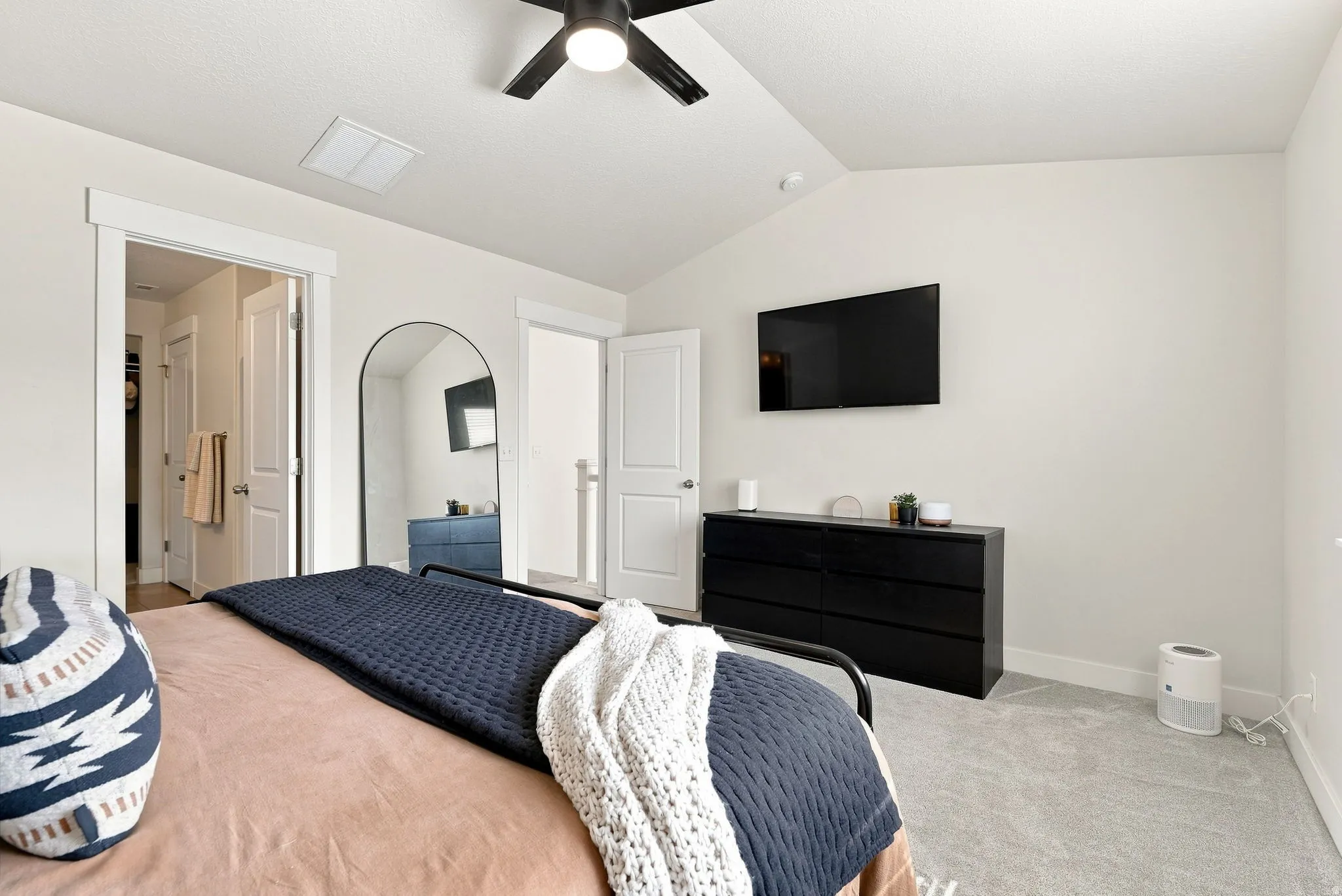 Primary Suite, vaulted ceiling with a ceiling fan