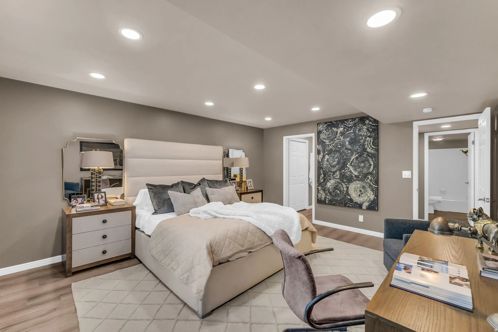 Recessed lighting, wood-finish flooring, and white trim