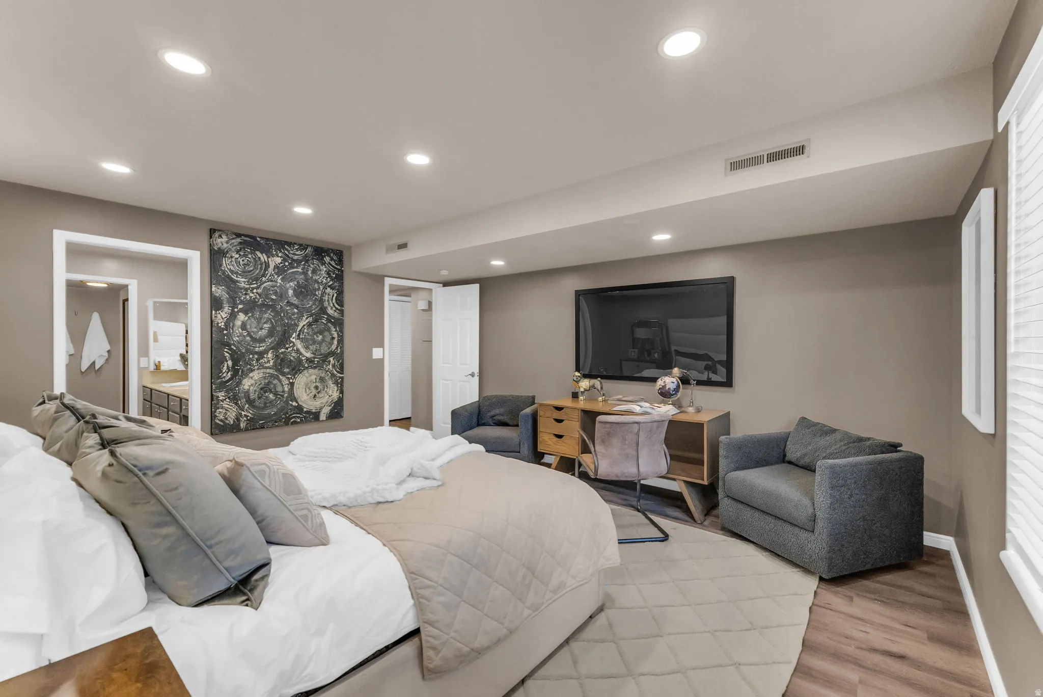 Recessed lighting throughout, wood-finish flooring, and a neutral wall color
