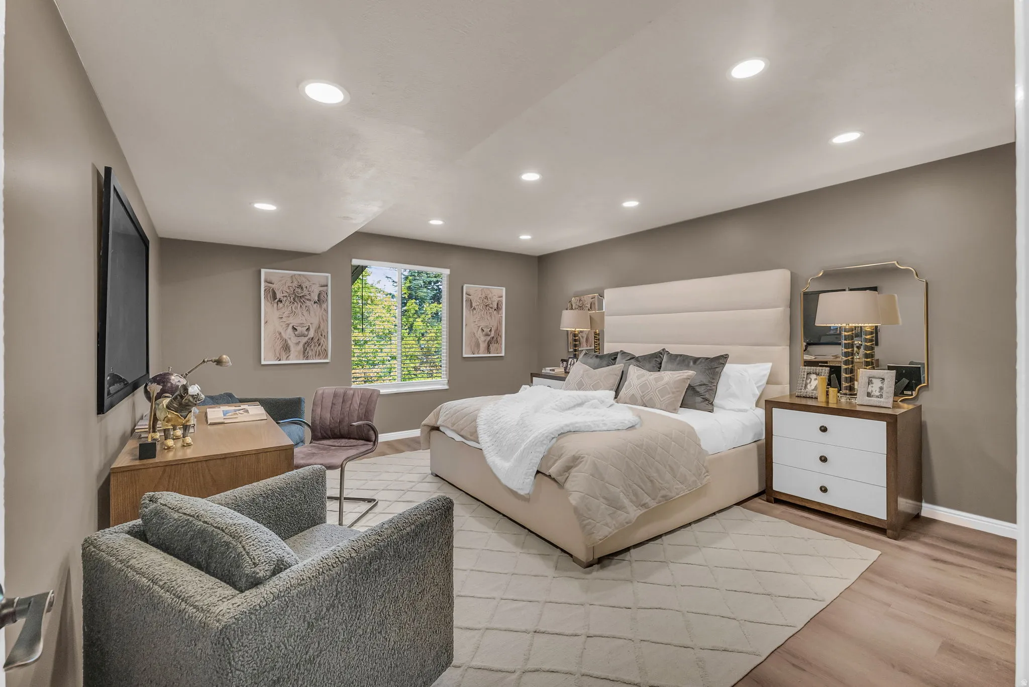 Recessed lighting, wood-finish flooring, and a large window with blinds