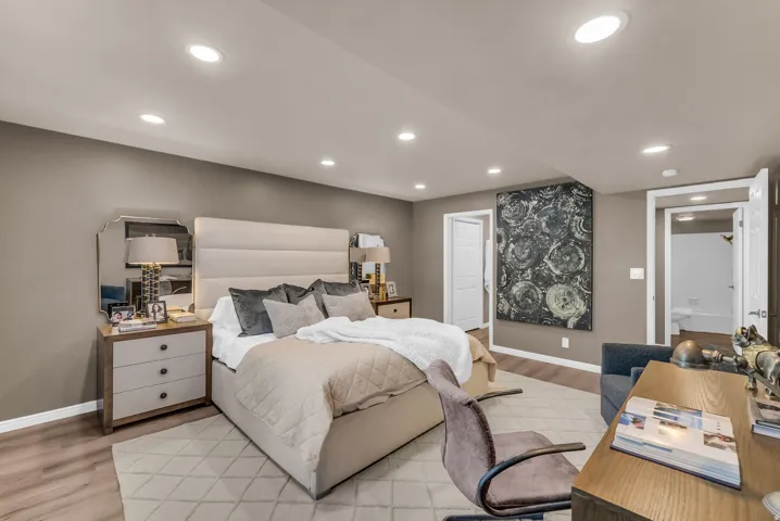 Recessed lighting, wood-finish flooring, and white trim