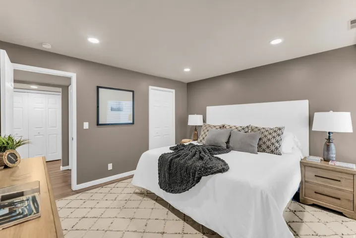 Recessed ceiling lighting, durable wood-finish flooring, two-panel bifold closet doors, and neutral wall tones