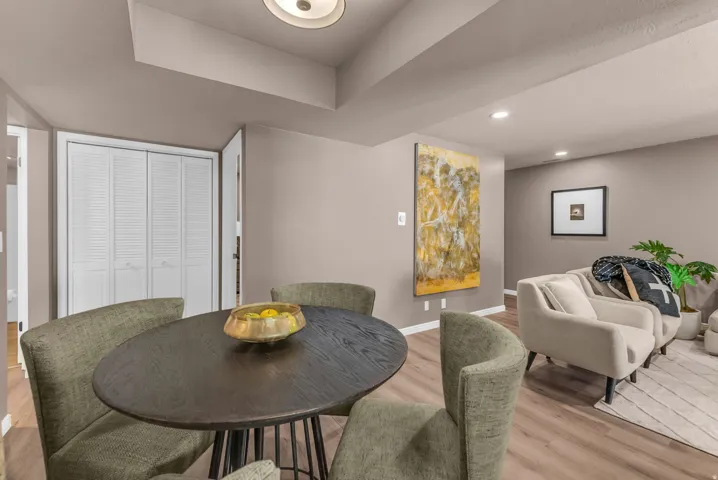 Wood-finish flooring throughout, featuring recessed lighting and a built-in closet with louvered bifold doors