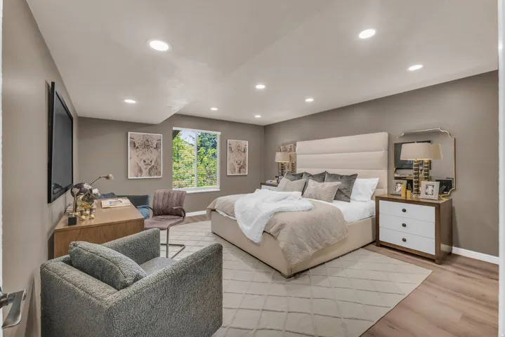 Recessed lighting, wood-finish flooring, and a large window with blinds
