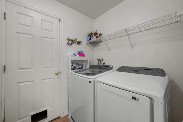 Utility area with wire shelving and a paneled door
