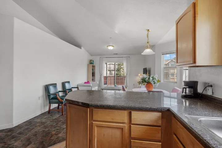 Kitchen island with a dark countertop and wood-finish cabinetry