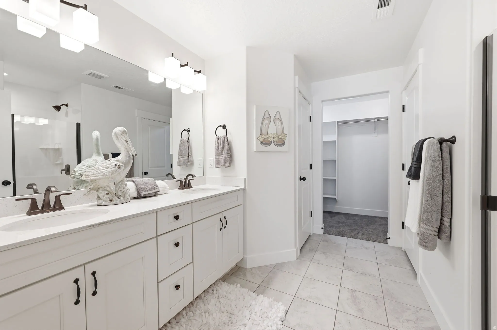 Double vanity with integrated sinks, set against a large wall mirror