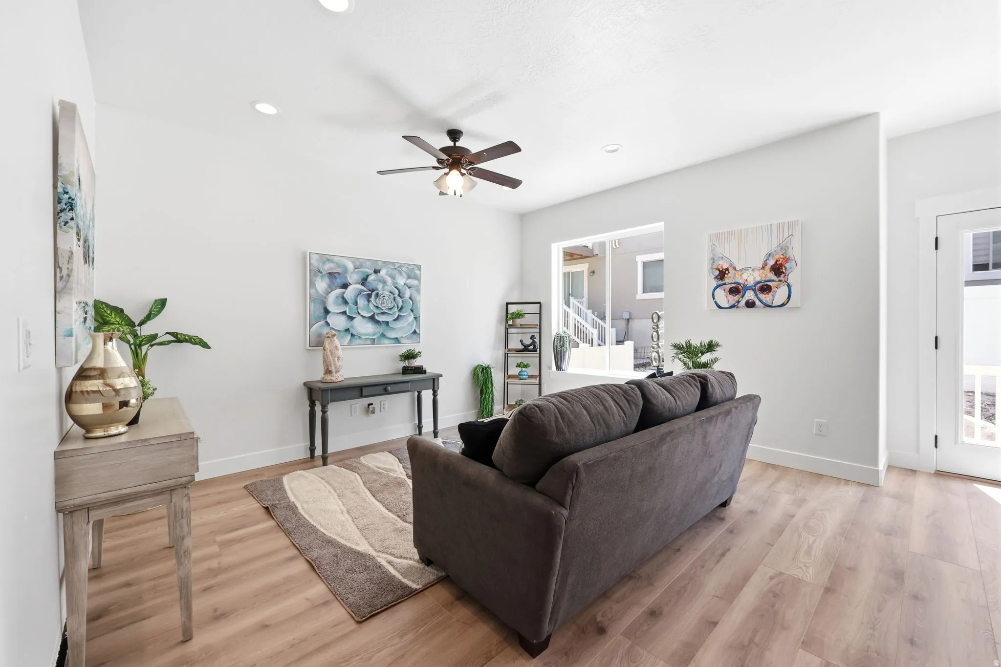 Living area featuring light wood-finish flooring, recessed lighting, and a ceiling fan