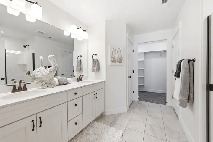 Double vanity with integrated sinks, set against a large wall mirror