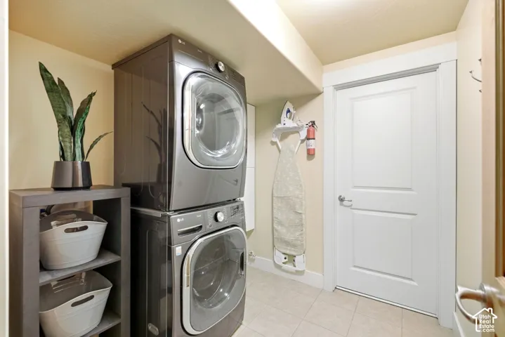Laundry area with tile flooring and a built-in shelving unit