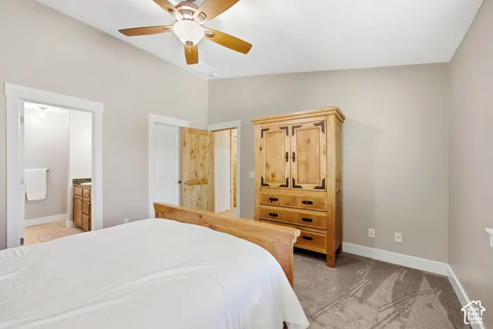 Vaulted ceiling with a ceiling fan, carpeted flooring, and white trim