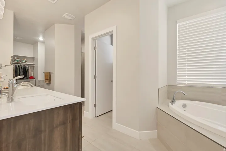 Wood-finish vanity with an integrated rectangular sink, set against light-toned wall paint