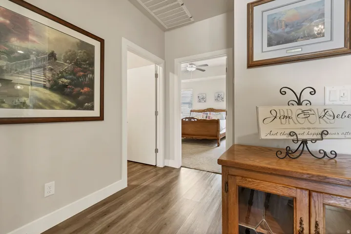 Wood-finish flooring throughout, bright white trim, and light wall tones