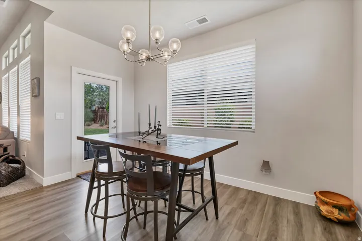 Wood-finish flooring throughout, complemented by a contemporary chandelier