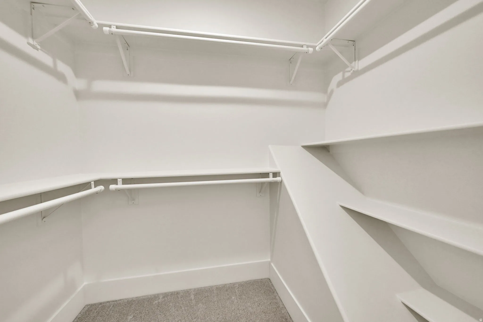 Built-in shelving and multiple hanging rods provide ample storage