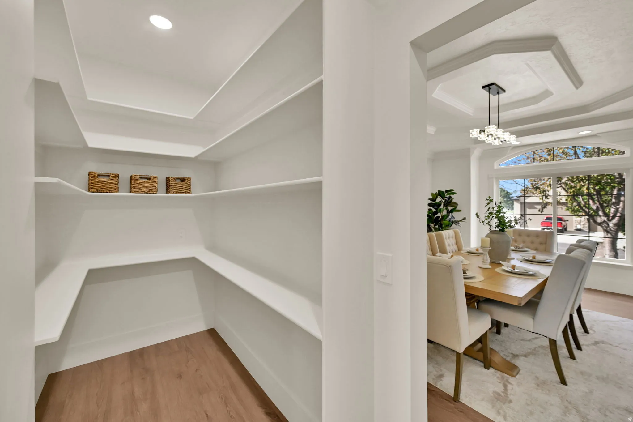Walk-in pantry with wood-finish flooring and recessed lighting