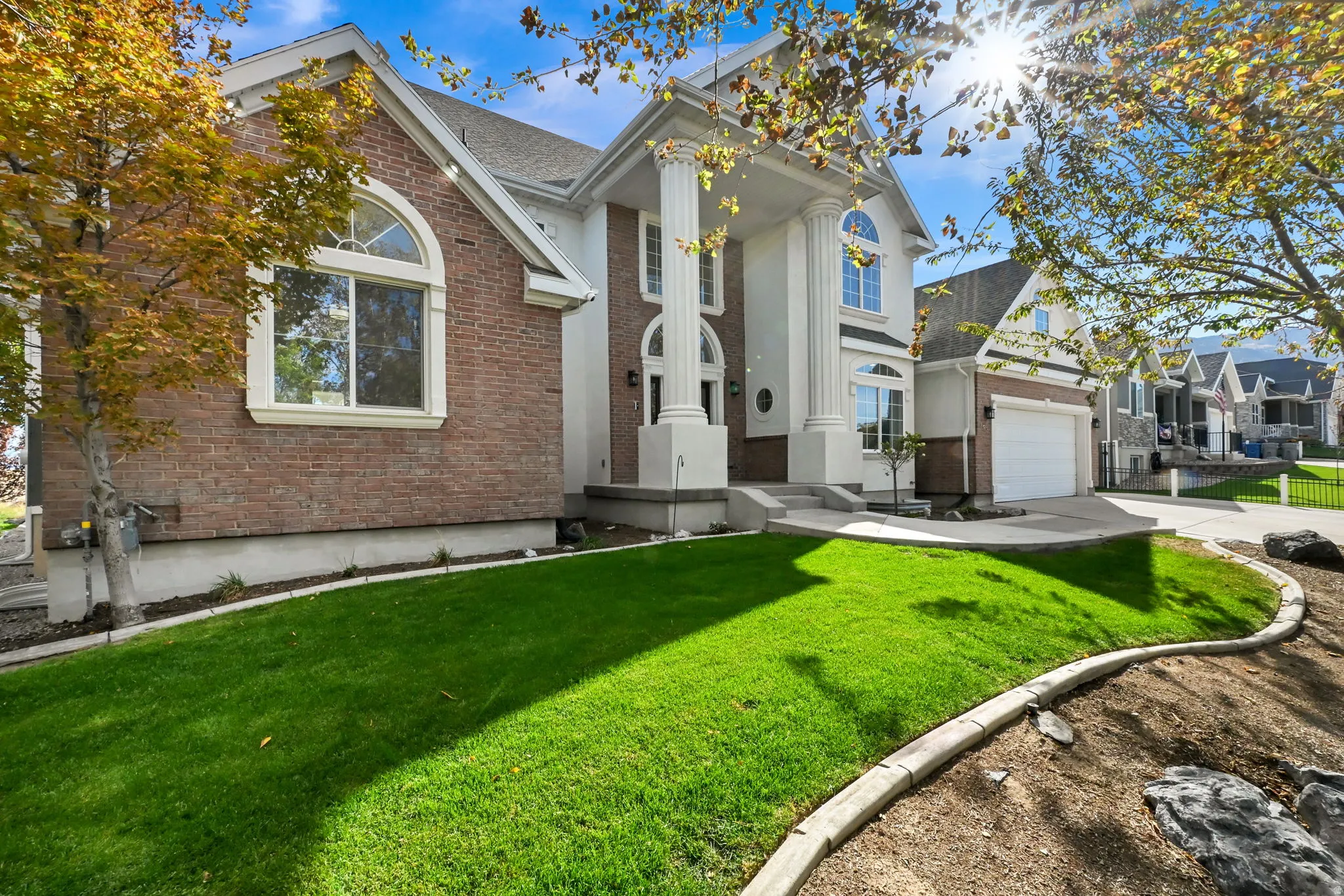 Brick and stucco exterior with prominent white columns