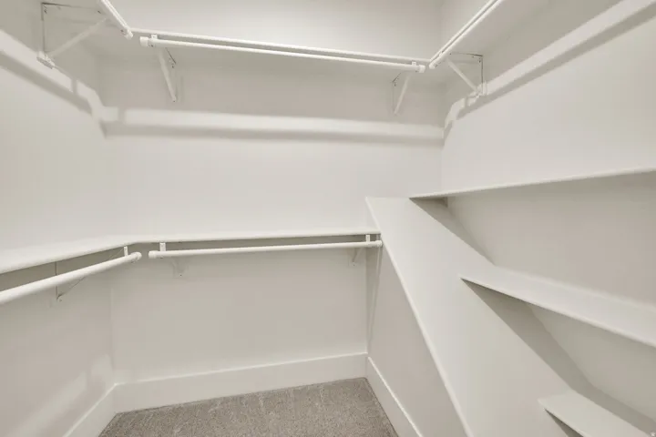 Built-in shelving and multiple hanging rods provide ample storage