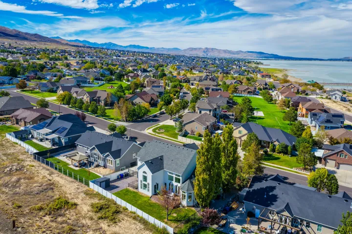 Residential neighborhood with mature trees, established landscaping, and mountain backdrop