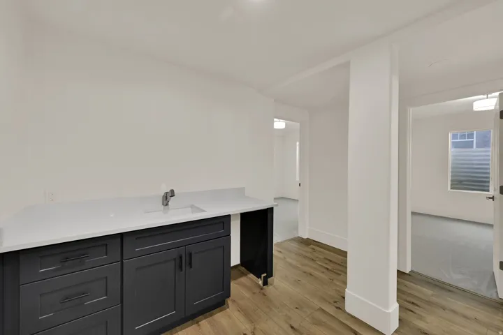 Built-in cabinetry with a white countertop and undermount sink