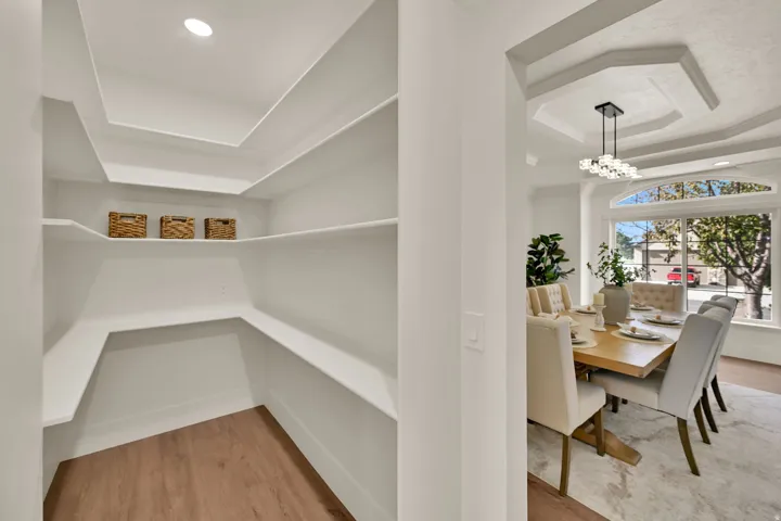 Walk-in pantry with wood-finish flooring and recessed lighting