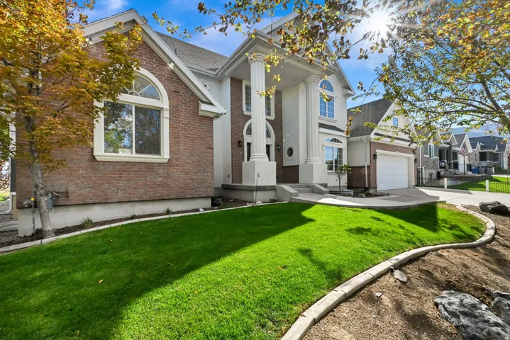 Brick and stucco exterior with prominent white columns