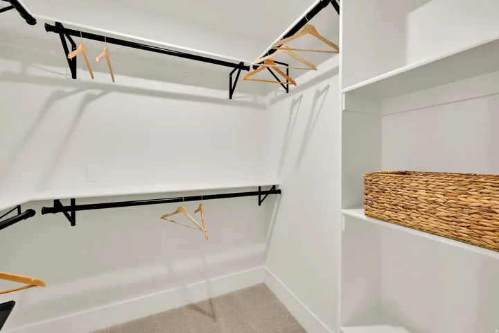 Primary Suite with his/her walk in closets integrated shelving and hanging rods