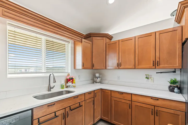 Wood-finish cabinetry and trim paired with light-toned countertops