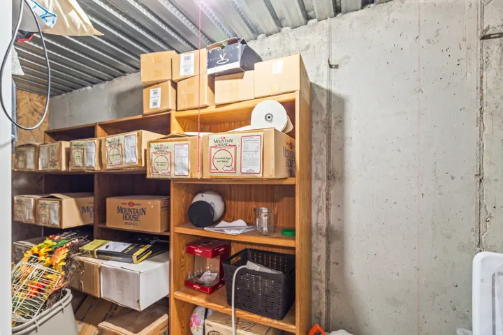 Built-in wood shelving units provide ample storage against concrete walls