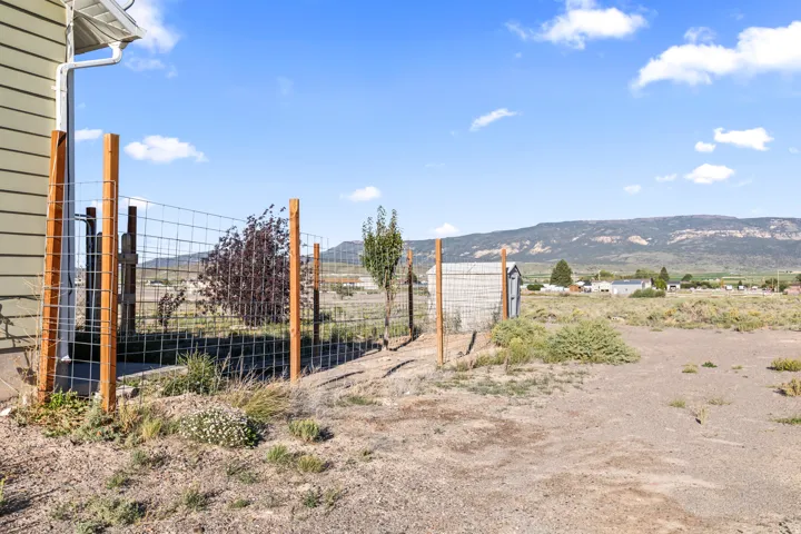 Perimeter fencing with wood posts and wire mesh