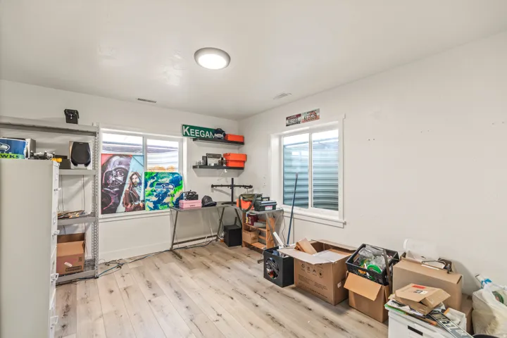Recessed lighting, wood-finish flooring, and white walls