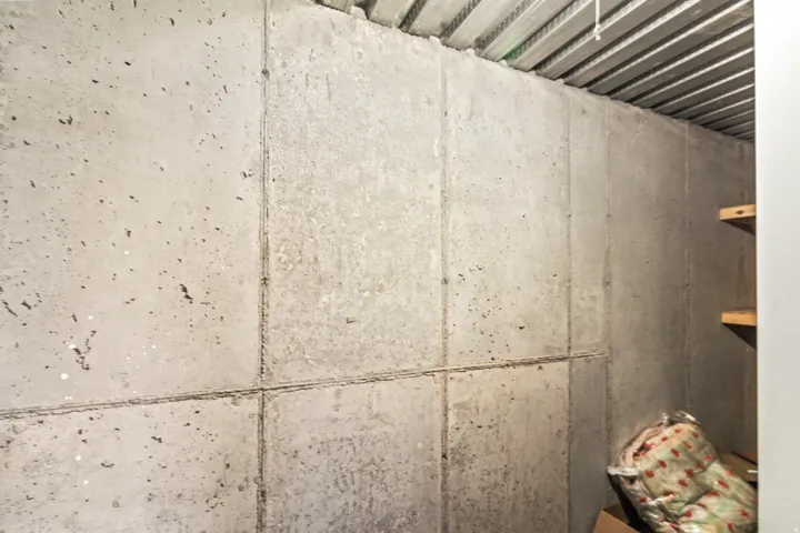 Concrete wall panels with wood shelving and corrugated metal ceiling