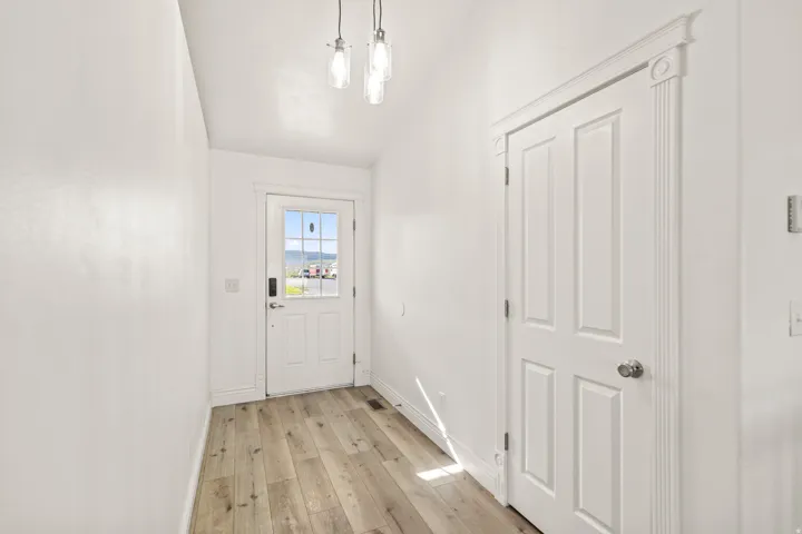 Wood-finish flooring with crisp white walls and ceiling
