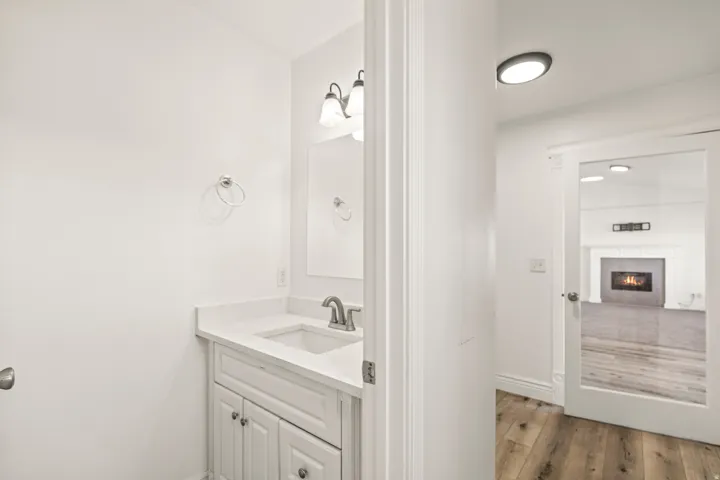 White vanity with an integrated sink and stone countertop