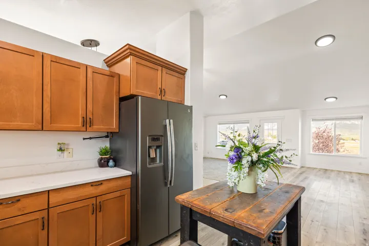 Kitchen featuring wood cabinetry, white countertops, and a stainless steel refrigerator