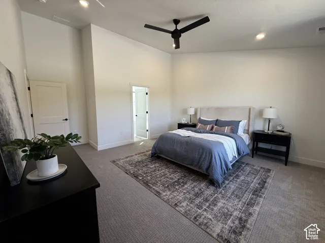 Plush carpeting, recessed lighting, and a contemporary ceiling fan