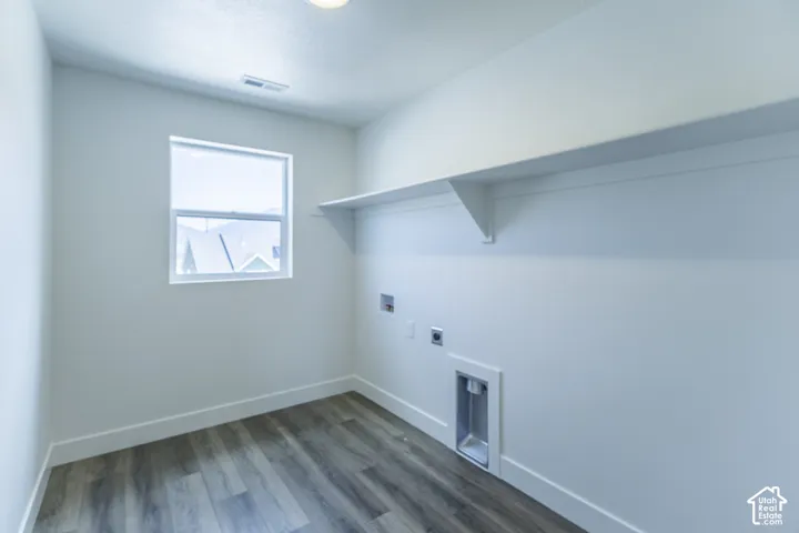 Wood-finish flooring, single window, white walls, built-in shelving, appliance hookups